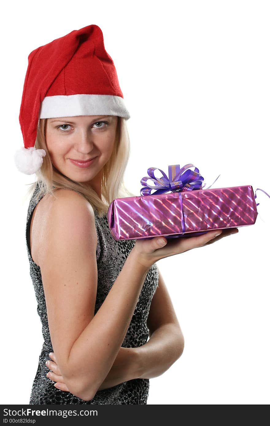 The young woman in red cap Santa with a gift in a hand. The young woman in red cap Santa with a gift in a hand