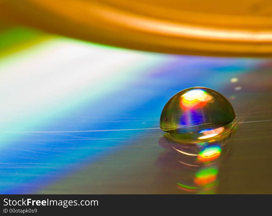 Water drop on old CD plate, interested interference colours. Visible scratches. Water drop on old CD plate, interested interference colours. Visible scratches.