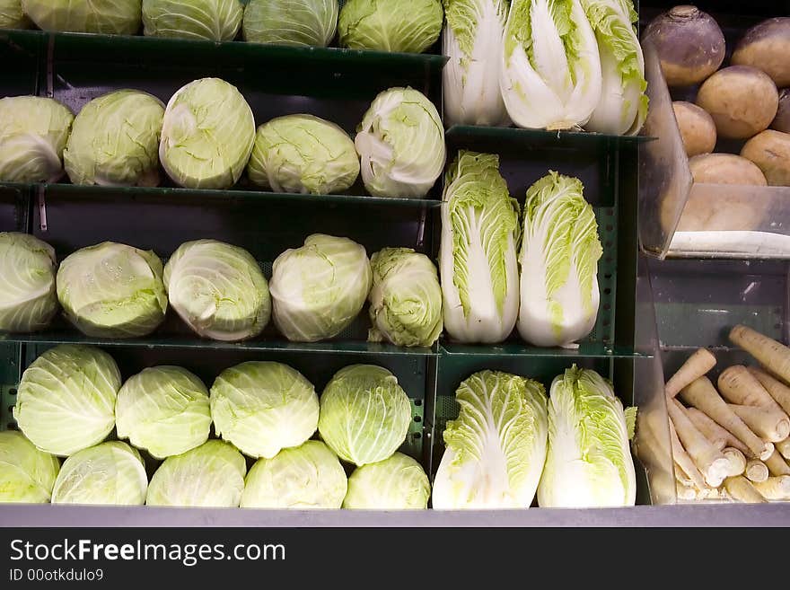 Grocery shelves full of cabbage and turnips