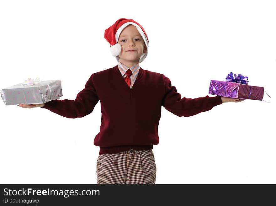 The boy in a sweater and cap Santa holds two gifts