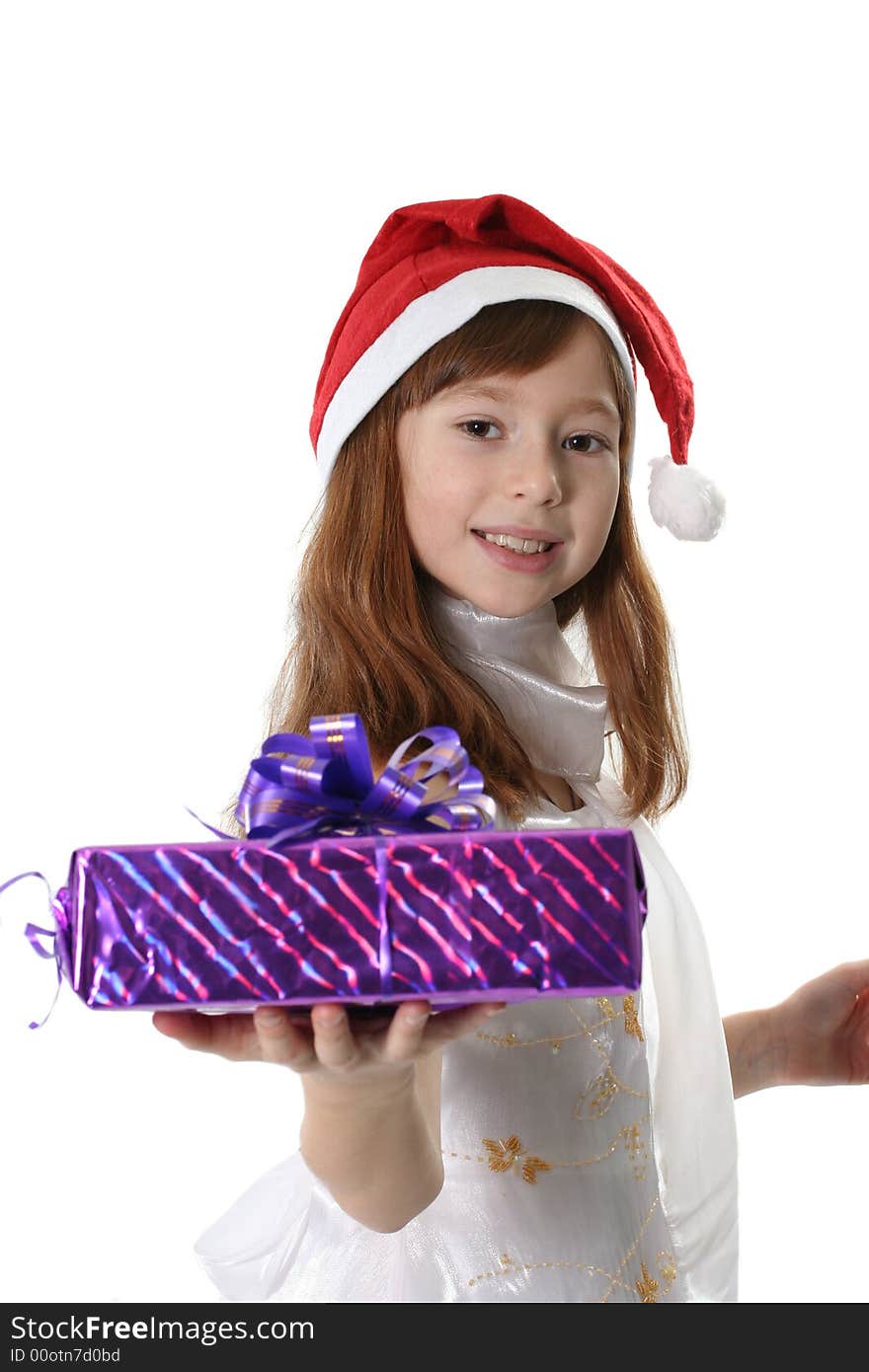 The girl in a white dress and cap Santa holds gift. The girl in a white dress and cap Santa holds gift