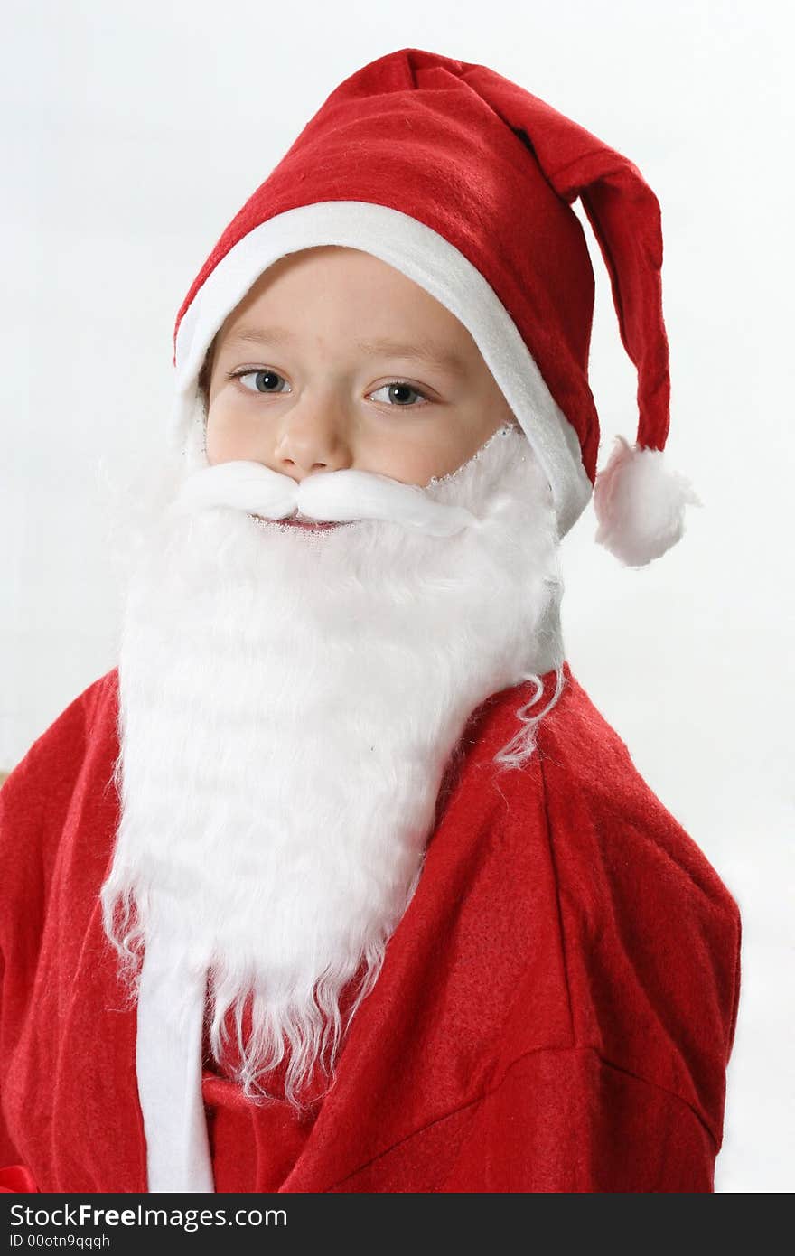 Portrait of a boy in cap Santa and white beard