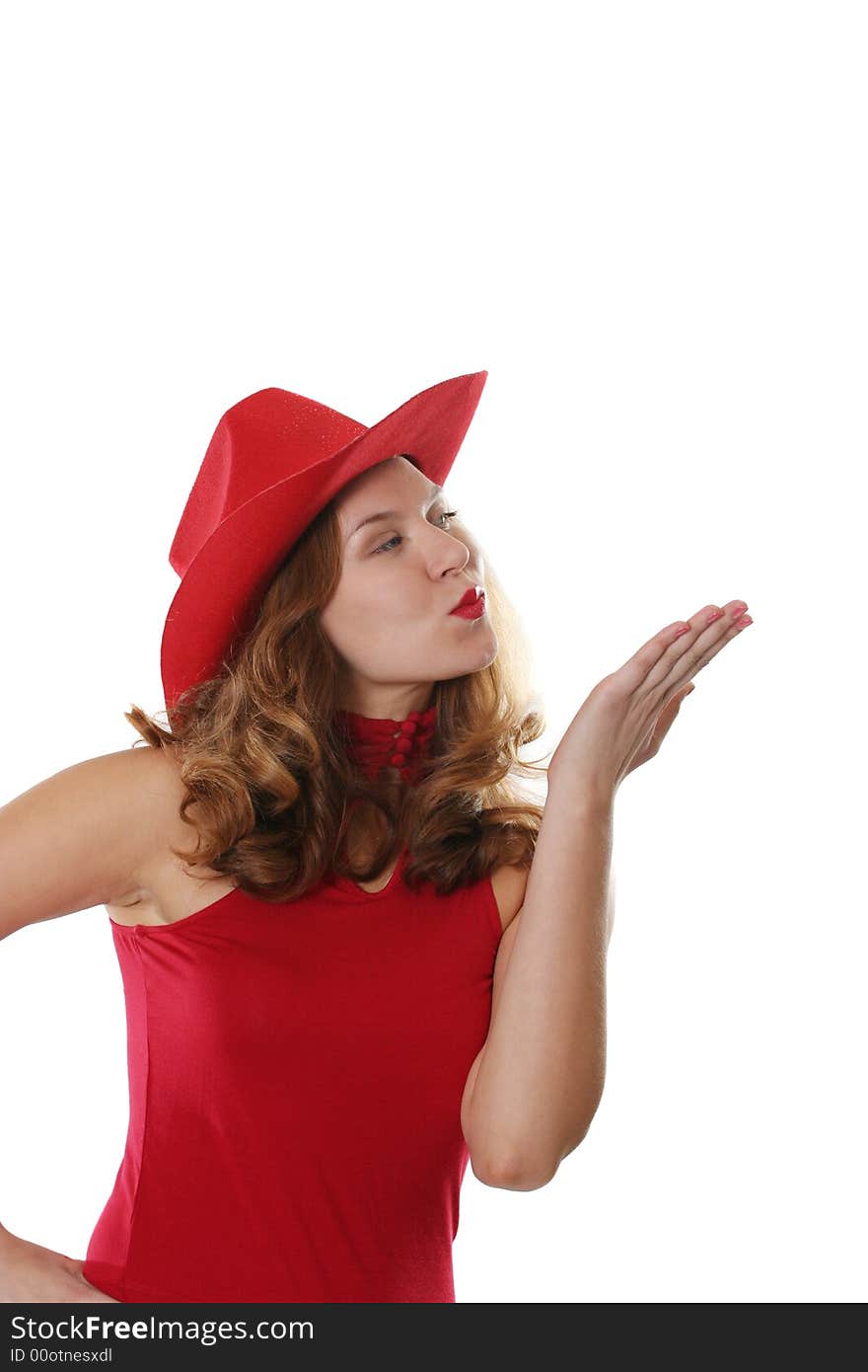 The girl in a red dress and a hat gives an air kiss