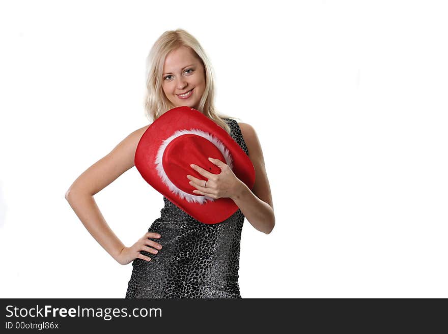 The beautiful young woman holds a red hat in a hand