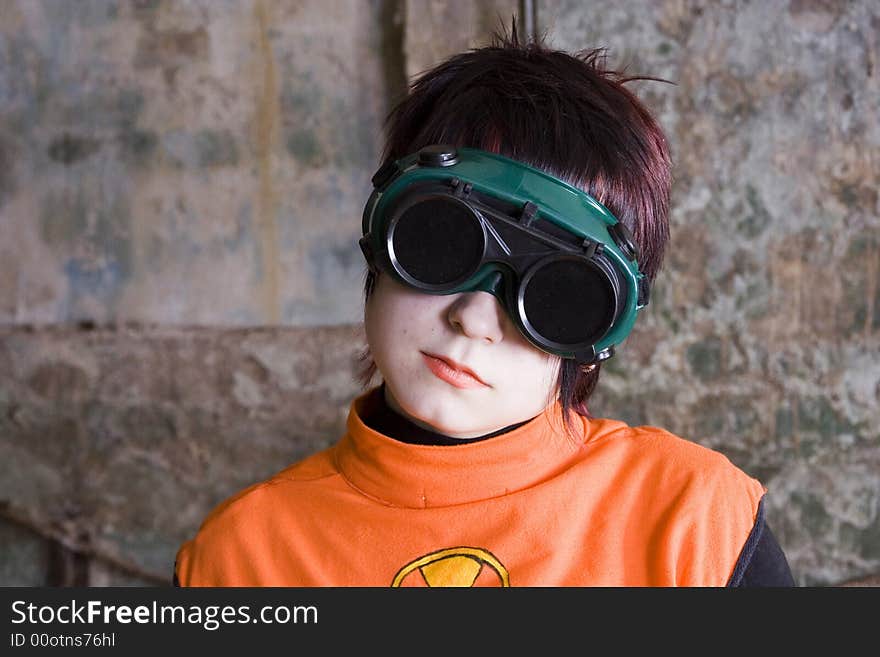 The girl in black protecting glasses and an orange jacket