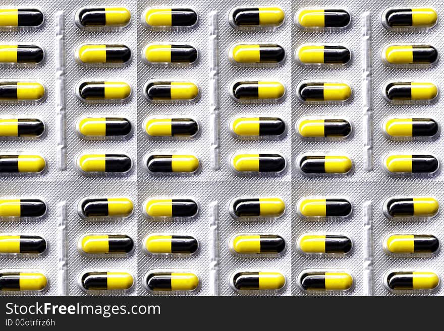 Yellow and black medical pills