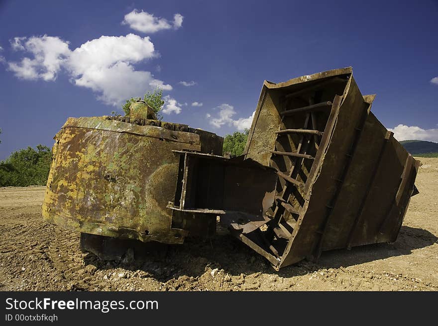 A Lonely old and rusty machinery on a clody sky on background