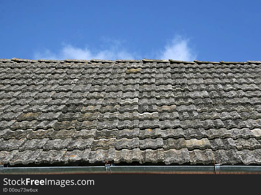 Roof tiled on a background of the dark blue sky