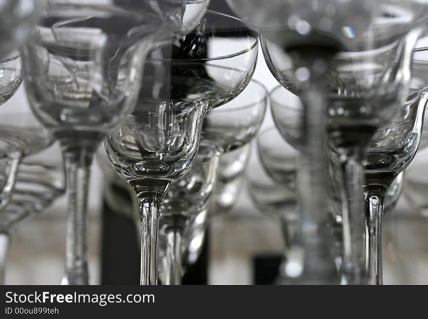 A shelf full of clean bar glasses in a bar