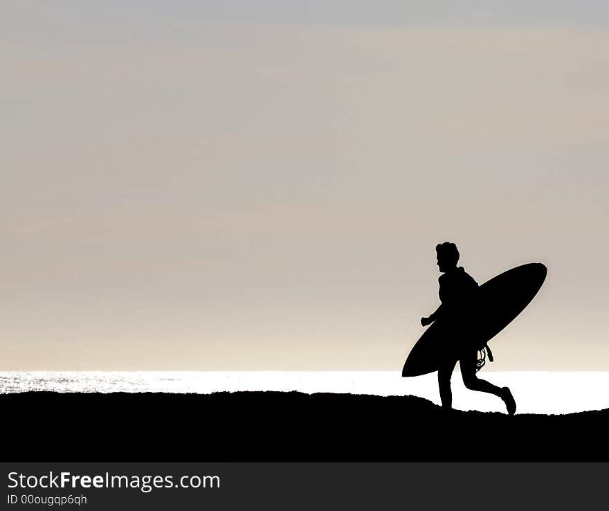 Surfer running along cliff