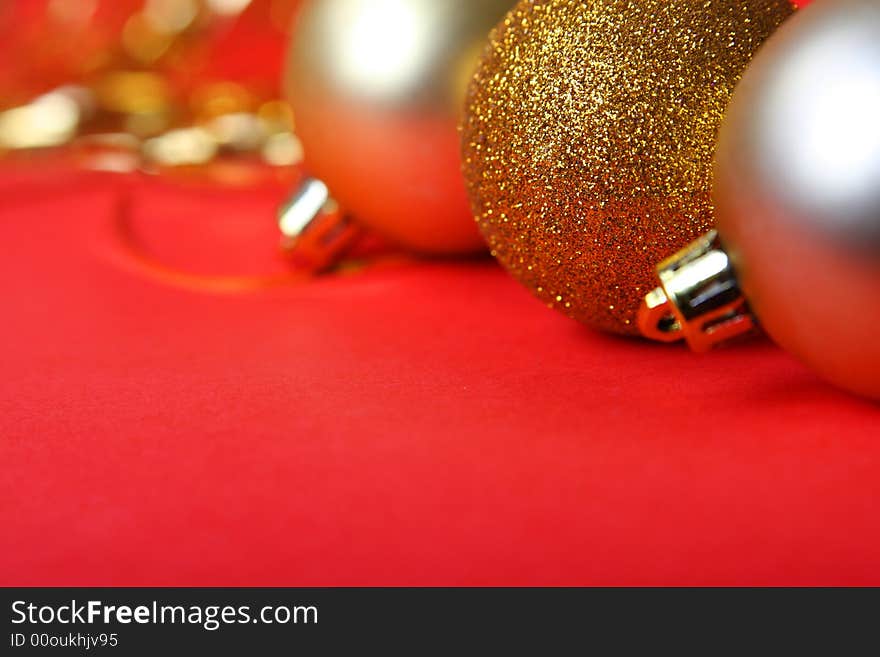 Christmas ornament, gold balls and red background