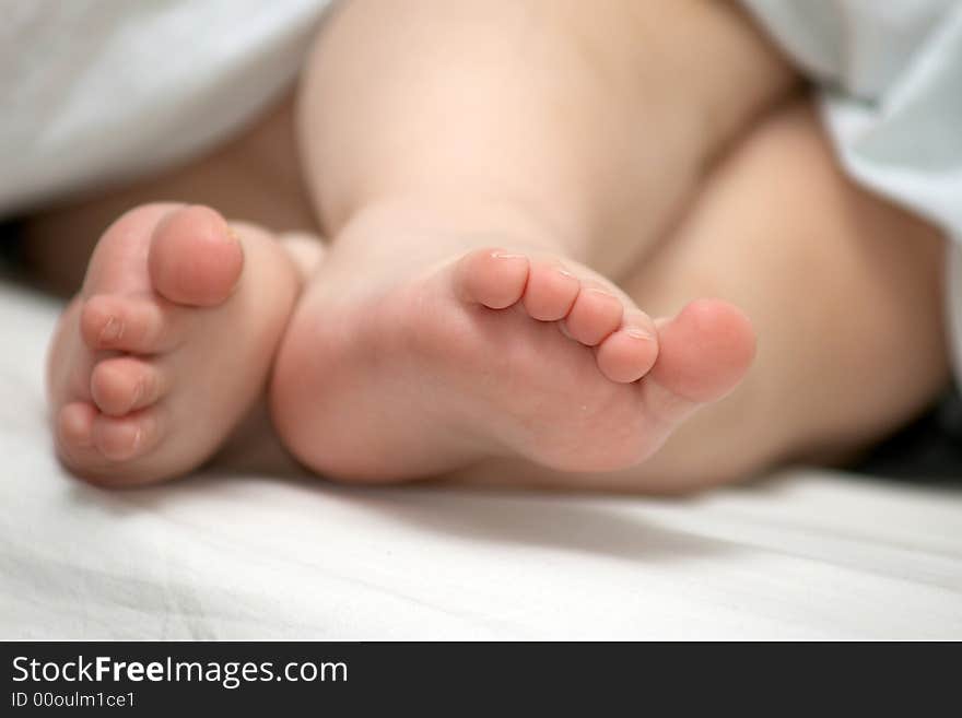 An image of little foots of sleeping baby