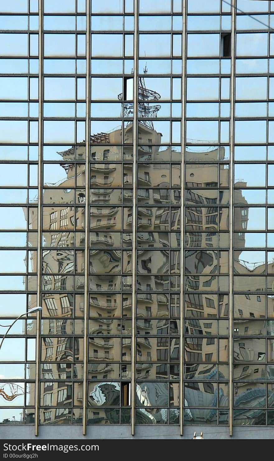 The deformed reflection of a building in mirror windows