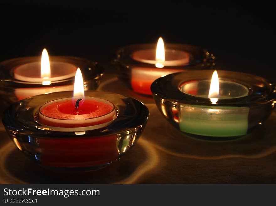 Four candles over a tablecloth