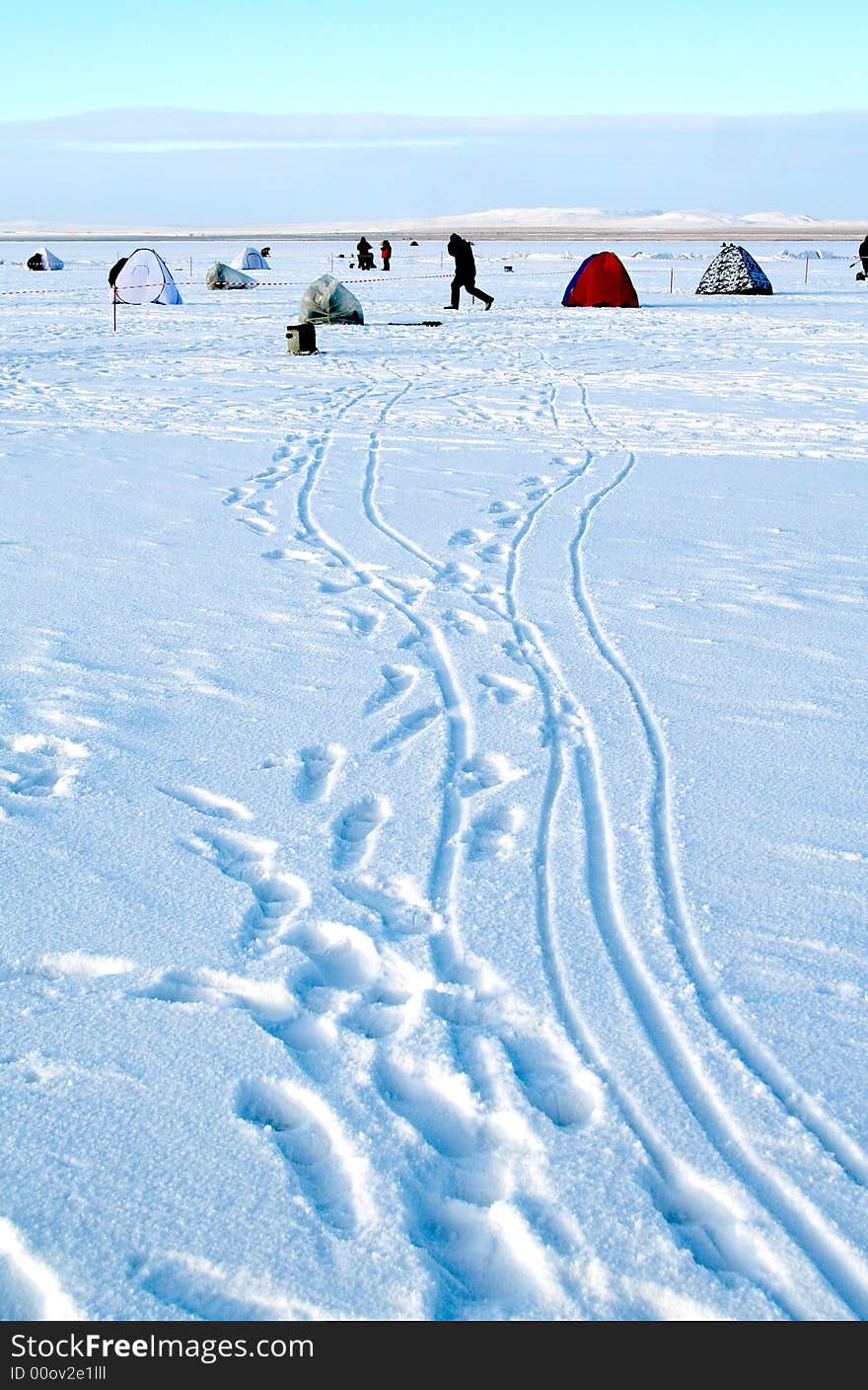 Fishing on an ice of the frozen lake. Fishing on an ice of the frozen lake