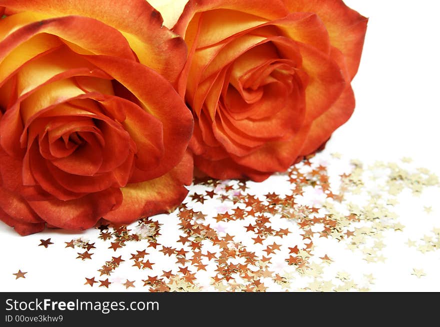 Two red roses and stars isolated over white background