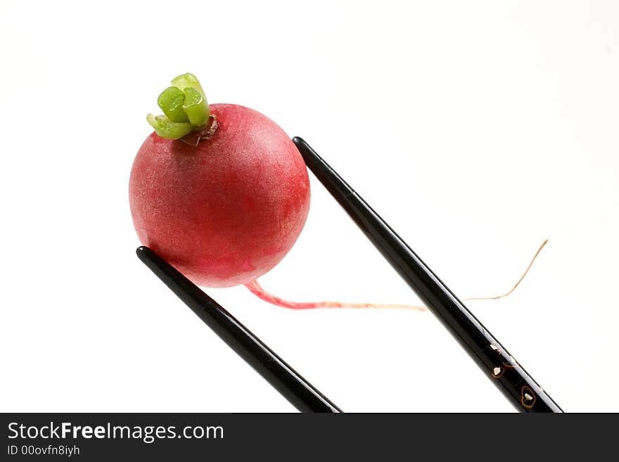 Fresh Radish held with black inlaid chopsticks. Fresh Radish held with black inlaid chopsticks