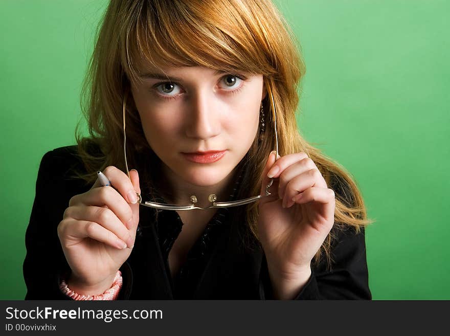 Studio portrait of a beautiful red head girl on green background. Studio portrait of a beautiful red head girl on green background