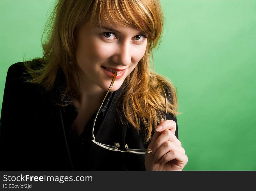 Studio portrait of a beautiful red head girl on green background. Studio portrait of a beautiful red head girl on green background