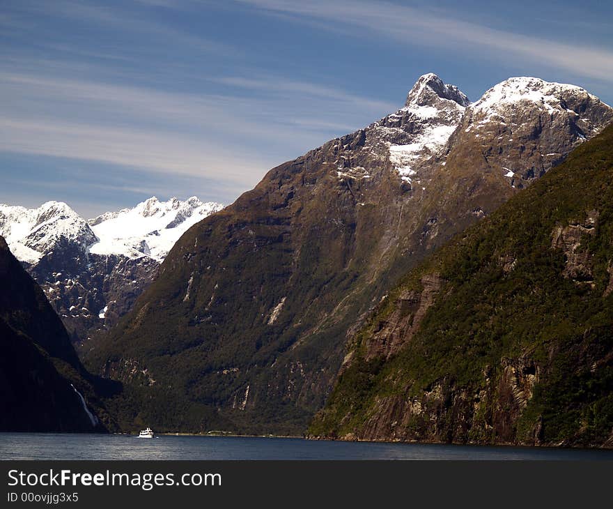 The road to Milford is one of New Zealand’s most scenic drives. The first part is relatively mild farmland, then you’ll ease into beech forest near the entrance to the Fiordland National Park. Look for the Avenue of the Disappearing Mountain and the Mirror Lakes. Beautiful Milford Sound, described by Rudyard Kipling as the ’eighth wonder of the world’. A cruise on Milford Sound will be an essential component of your time in Fiordland, or you can get up close and personal in a sea kayak. Tall waterfalls, vertical rock faces and seals are some of the things you’ll remember