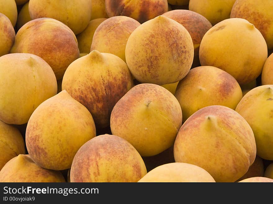 Fresh peaches on display at a farmer's market. Fresh peaches on display at a farmer's market