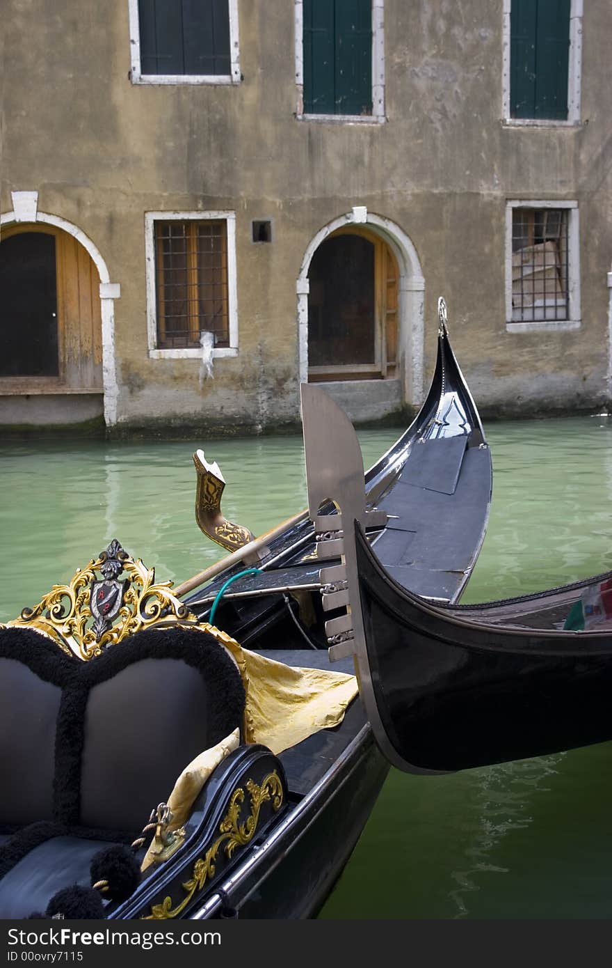 Two venecian gondolas in canal on the background of old ncient houses
