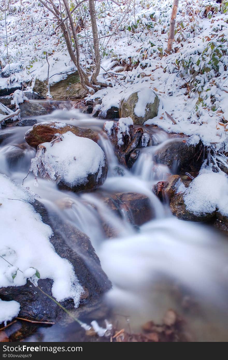 Mountain frozen torrent, winter season, vertical orientation. Mountain frozen torrent, winter season, vertical orientation