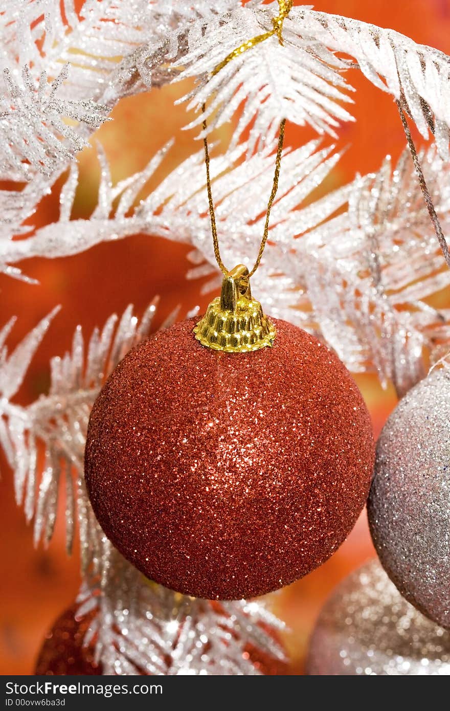 Red Christmas ball on white tree