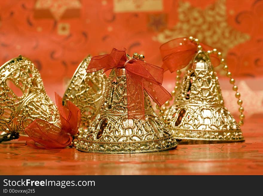 Golden Christmas bells with red ribbon