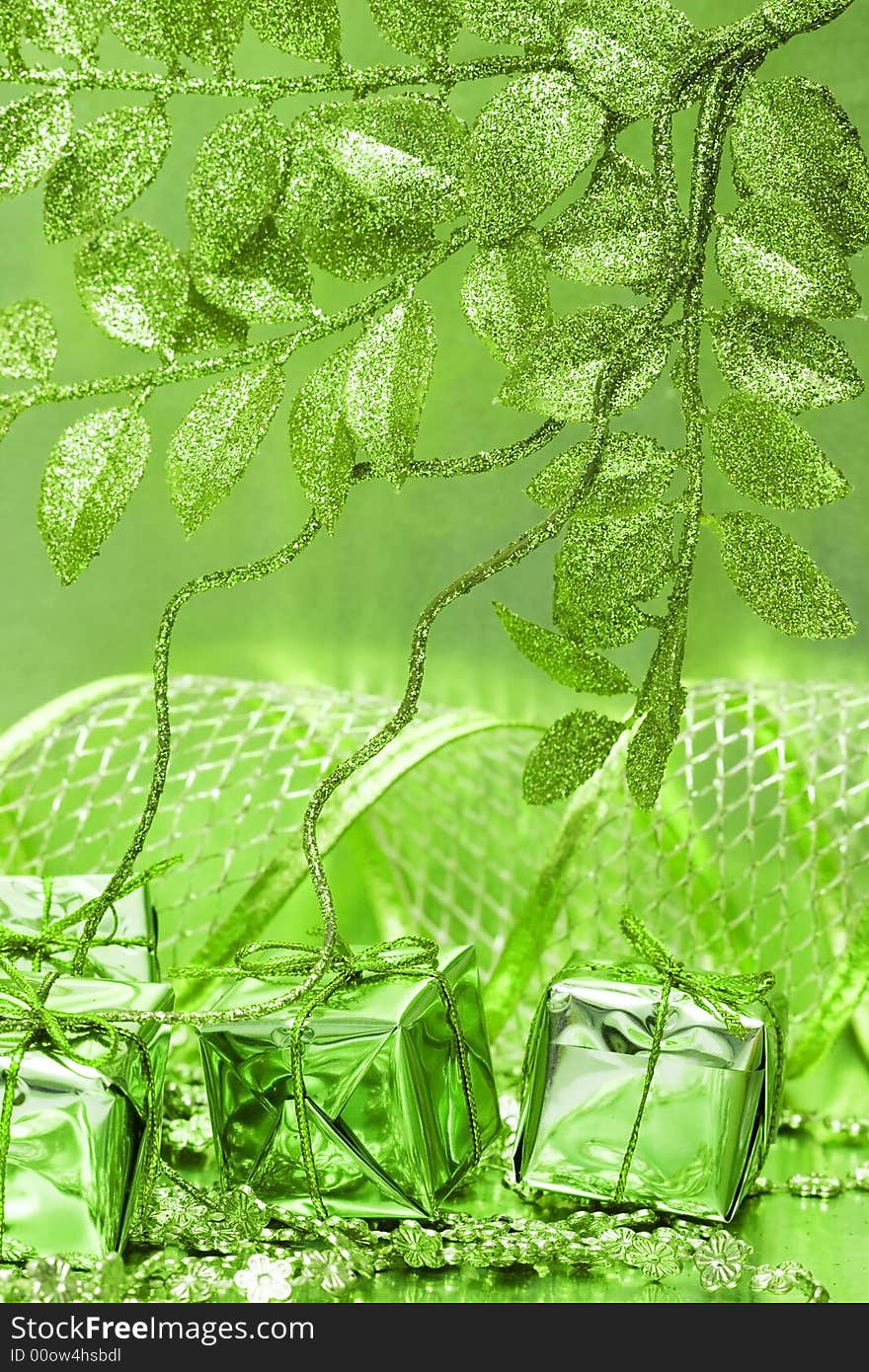 Gift boxes on green background with leaves