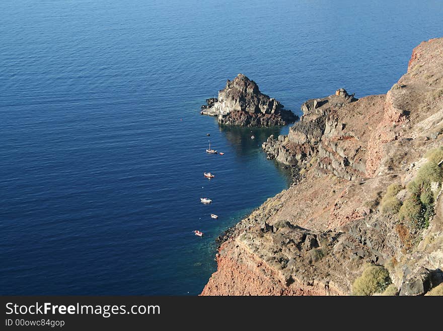 Rocks on the blue water. Rocks on the blue water