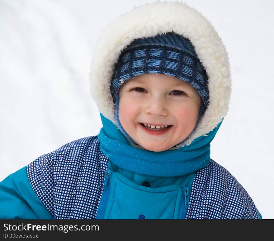 Cheerful boy on a background of a snow. Cheerful boy on a background of a snow