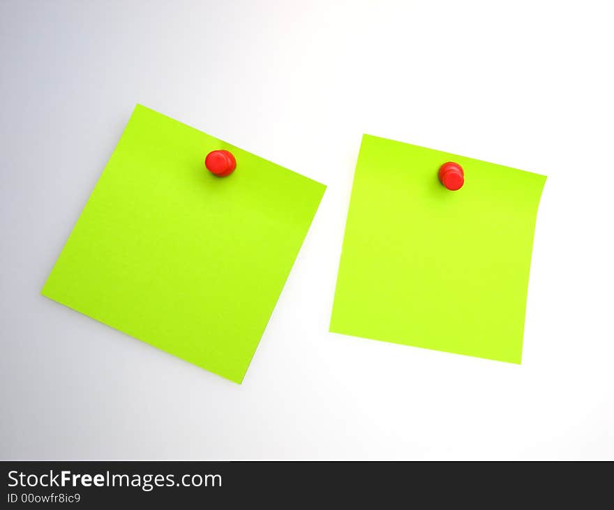 Two sheet of  green paper and  red writing button on  light background