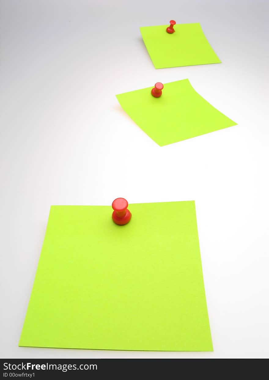 Three sheet of  green paper and  red writing button on  light background