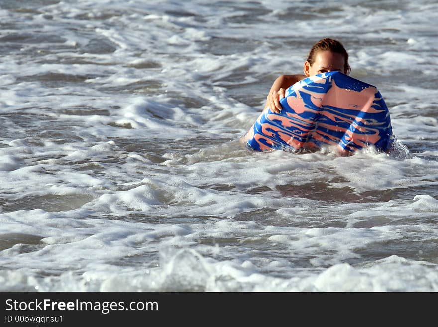 Bikini girl surfing on boogie board