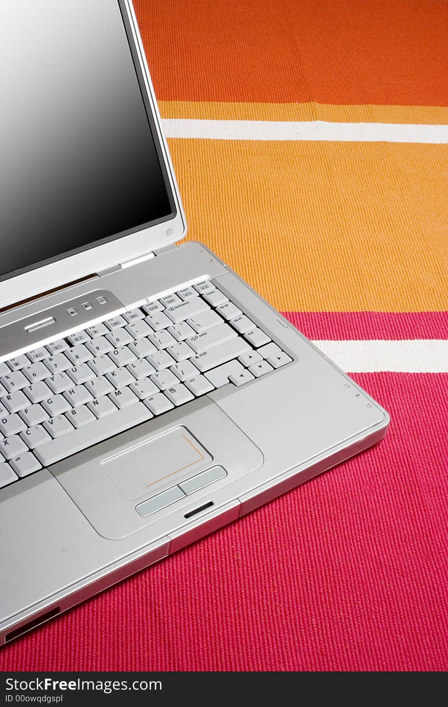 Laptop On A Colorful Rug