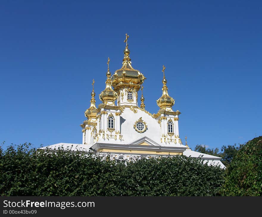 Snow-white church with gold cupola