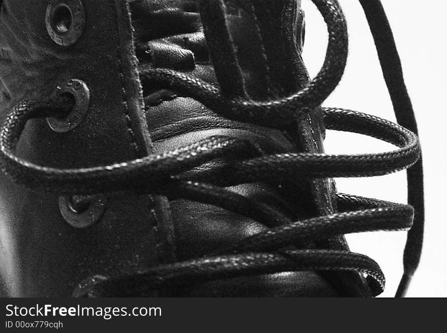 Black leather boot with laces on white back ground. Black leather boot with laces on white back ground