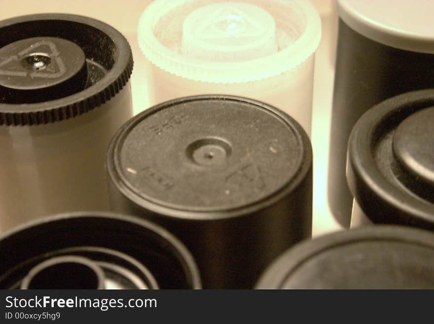 Films rolls, assorted orange, white and black topped 35mm film rolls for film processing