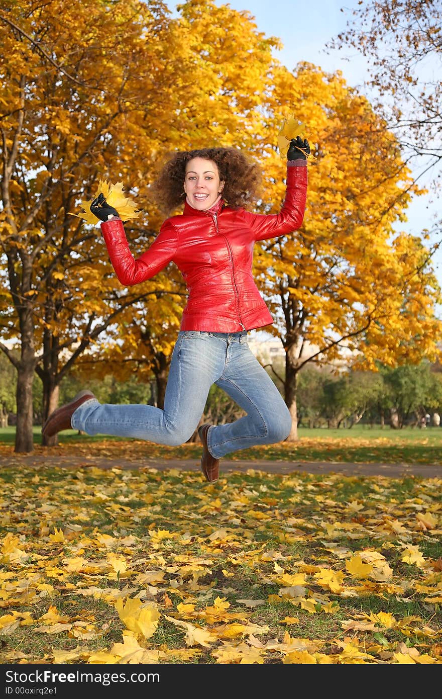 Girl in the red jacket jumps in the park in autumn 2. Girl in the red jacket jumps in the park in autumn 2