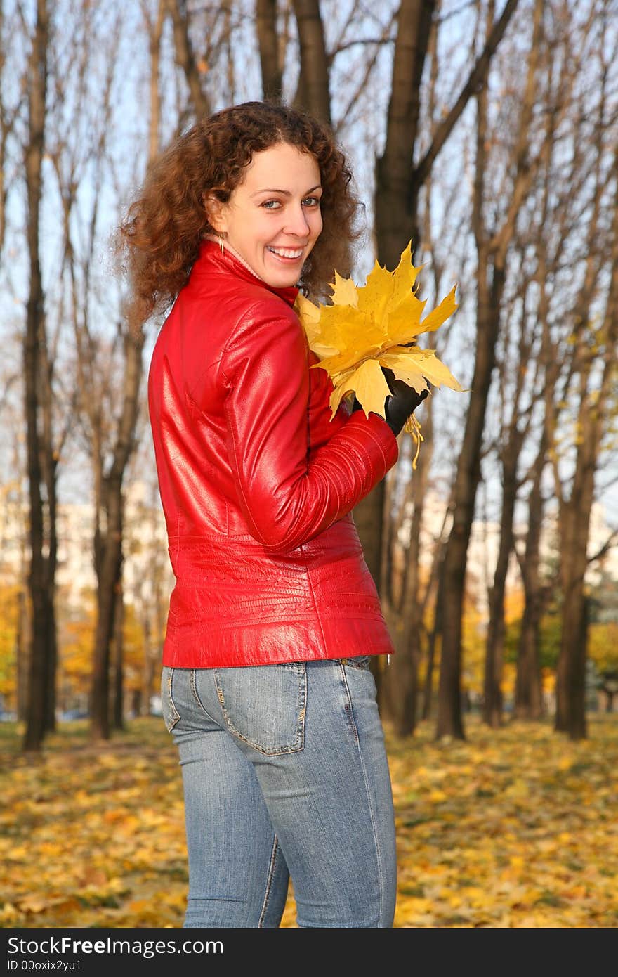 Girl in the park in autumn with yellow leaves