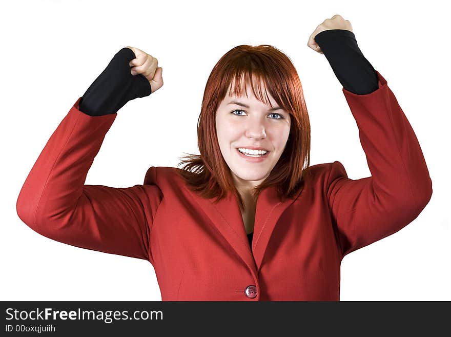 Cute girl with red hair dressed in a red business dress with her arms raised smiling and rejoicing for a win. Studio shot. Cute girl with red hair dressed in a red business dress with her arms raised smiling and rejoicing for a win. Studio shot.