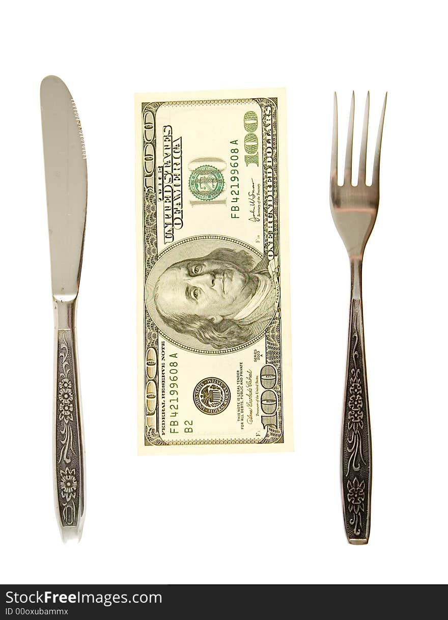 One hundret dollars lying between fork and knife. One hundret dollars lying between fork and knife