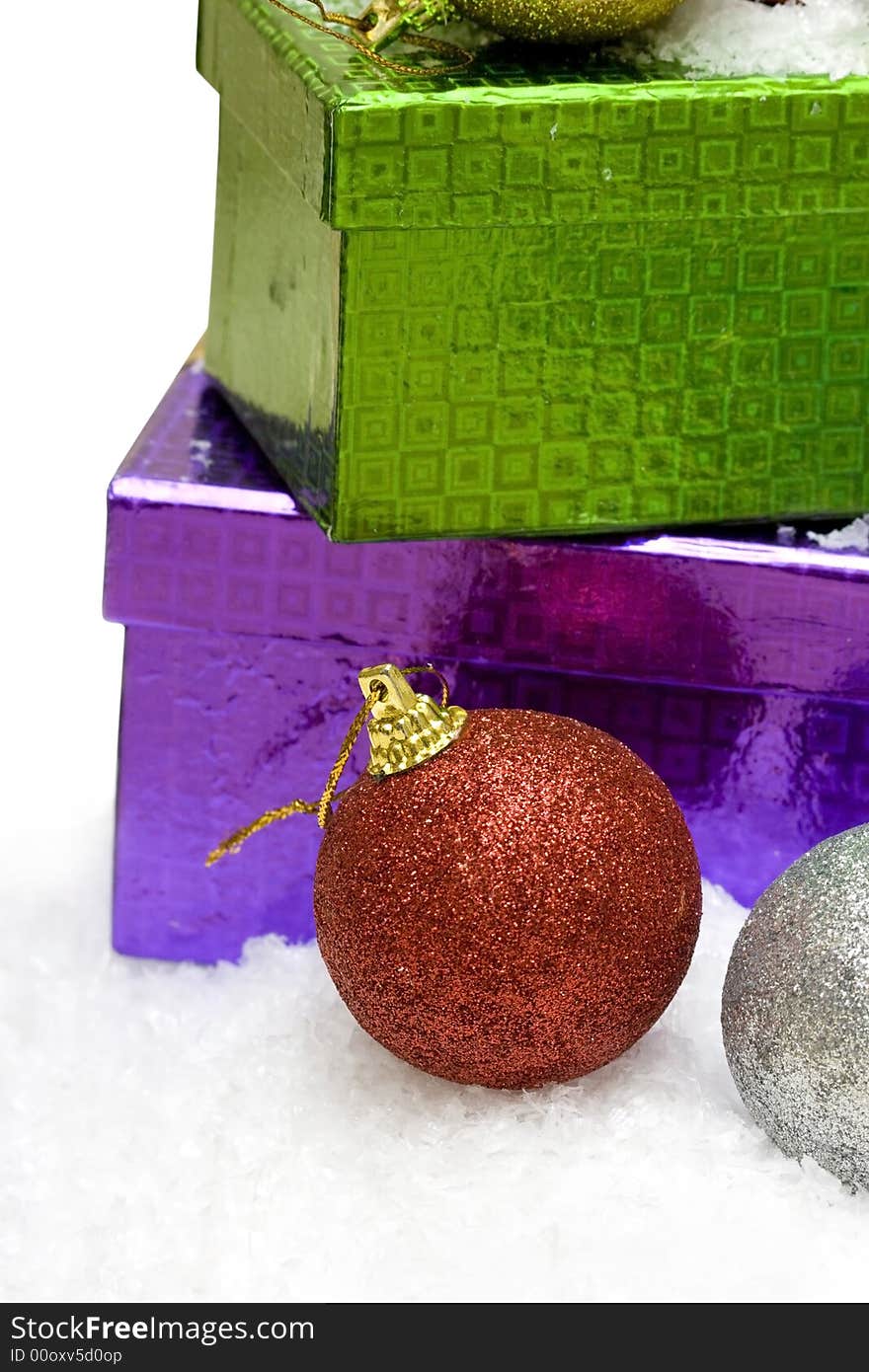 Christmas balls and gift boxes on snow