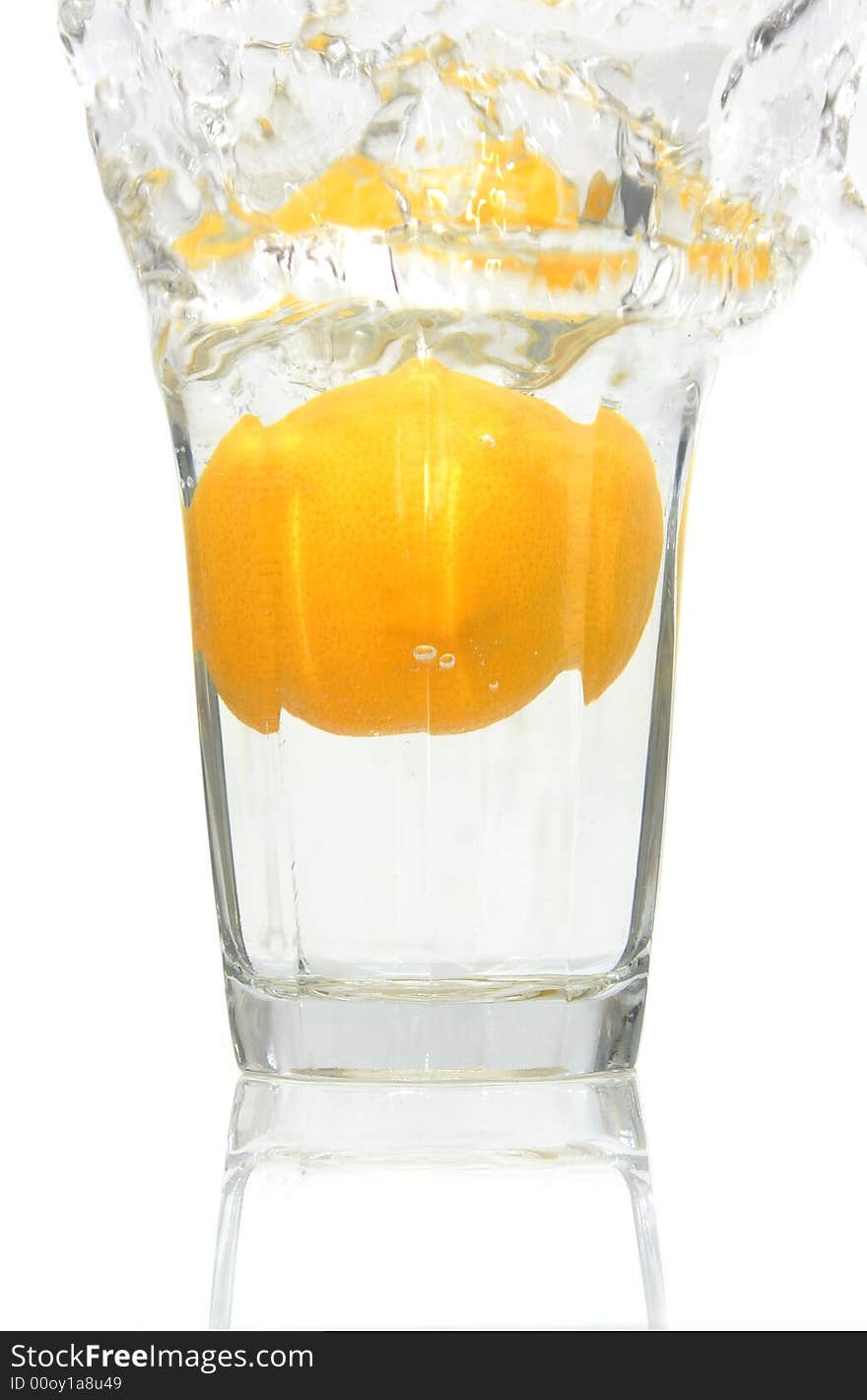 Lemon falling into a glass of ice cold water. Lemon falling into a glass of ice cold water