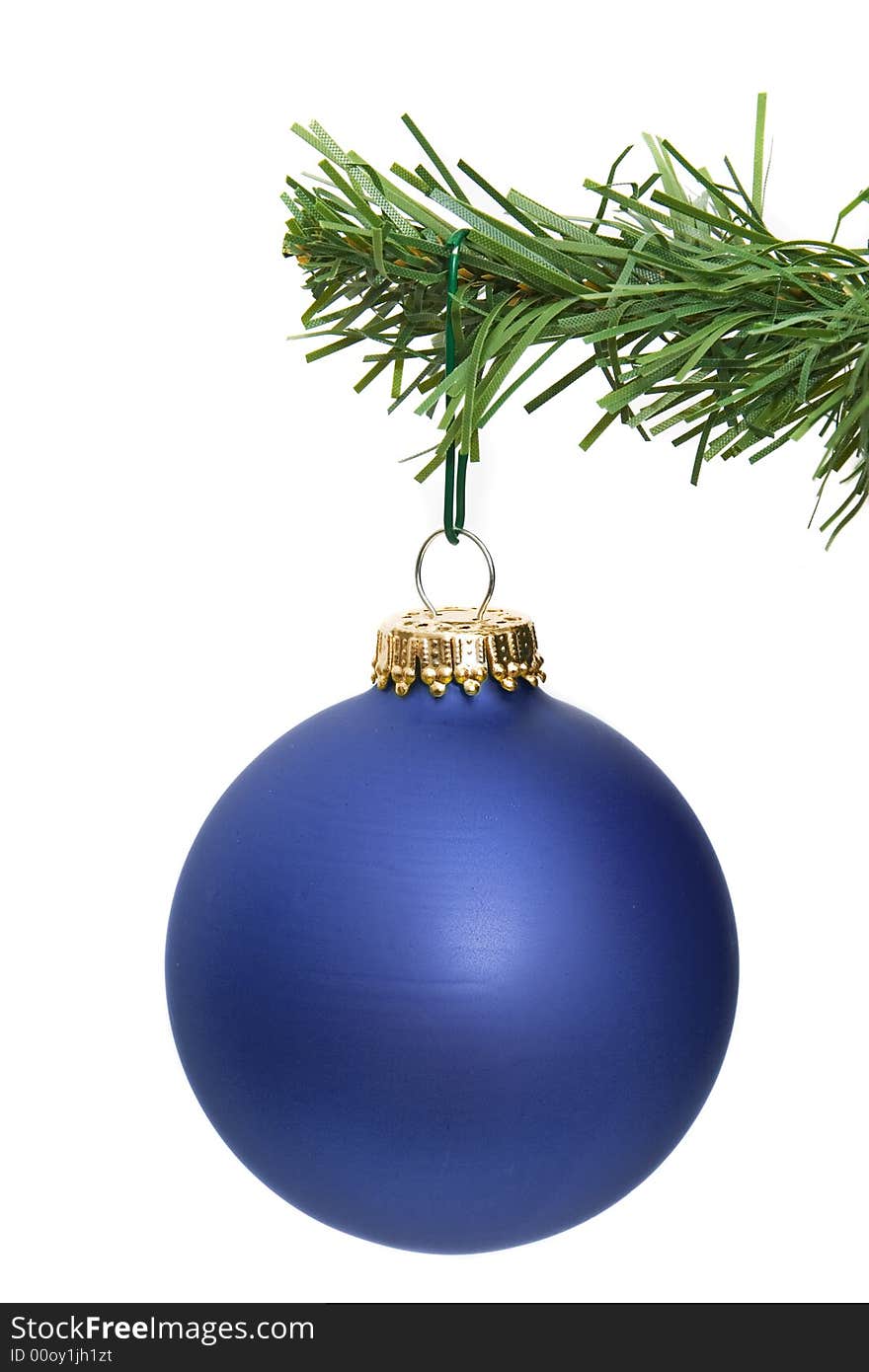 Blue ornament hanging on a pine tree branch