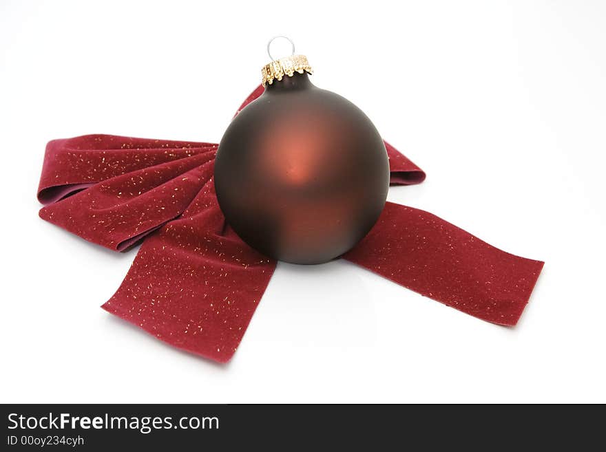 Red bow and an ornament isolated against white background