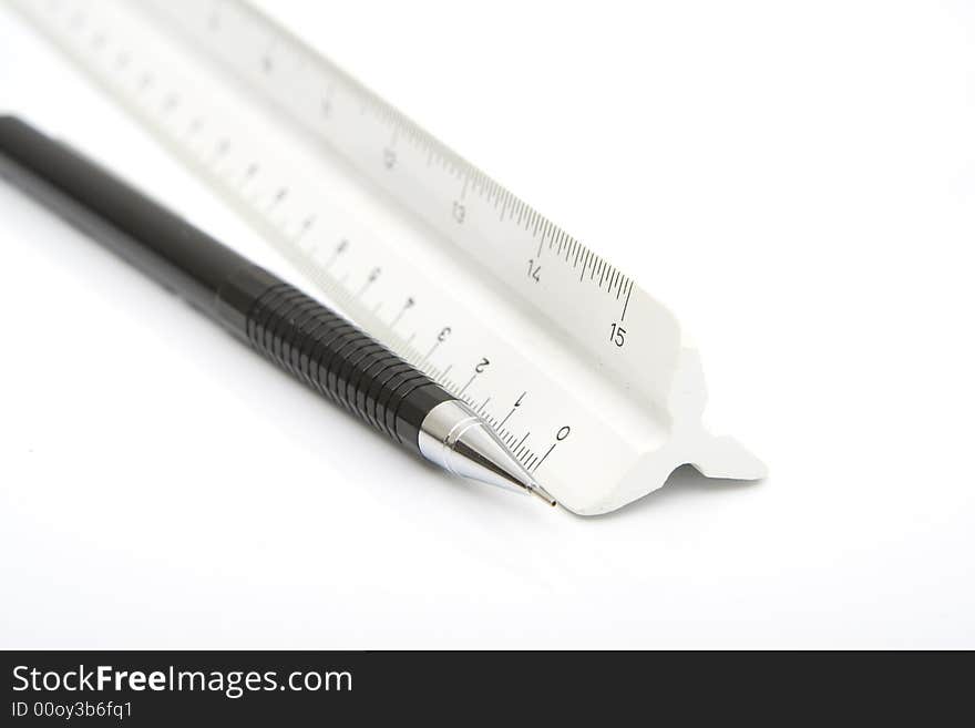 Pencil and ruler isolated against white background