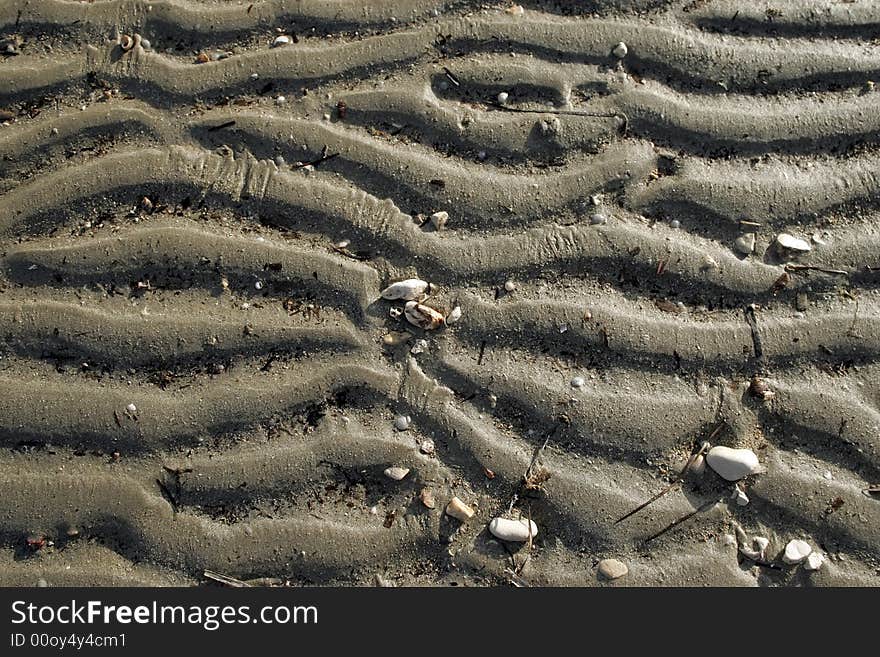 Small wave ripples in the sand at low tide . Background. Small wave ripples in the sand at low tide . Background