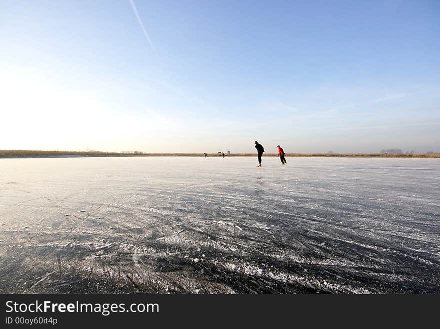 Ice skating on a wide open frozen lake in Holland